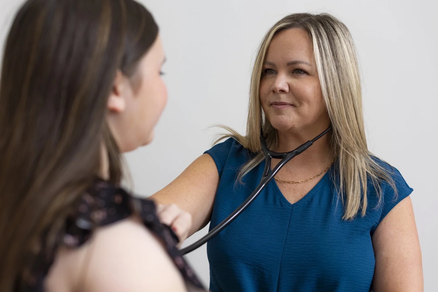 Nikki McWaters listening to a patient's heart